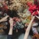 dried succulent parts - Top view of crop unrecognizable women standing near table and choosing dried flowers during workshop in daytime