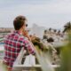 personal development - man reading book on balcony during daytim