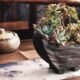 resilient succulents - a potted plant sitting on top of a wooden table